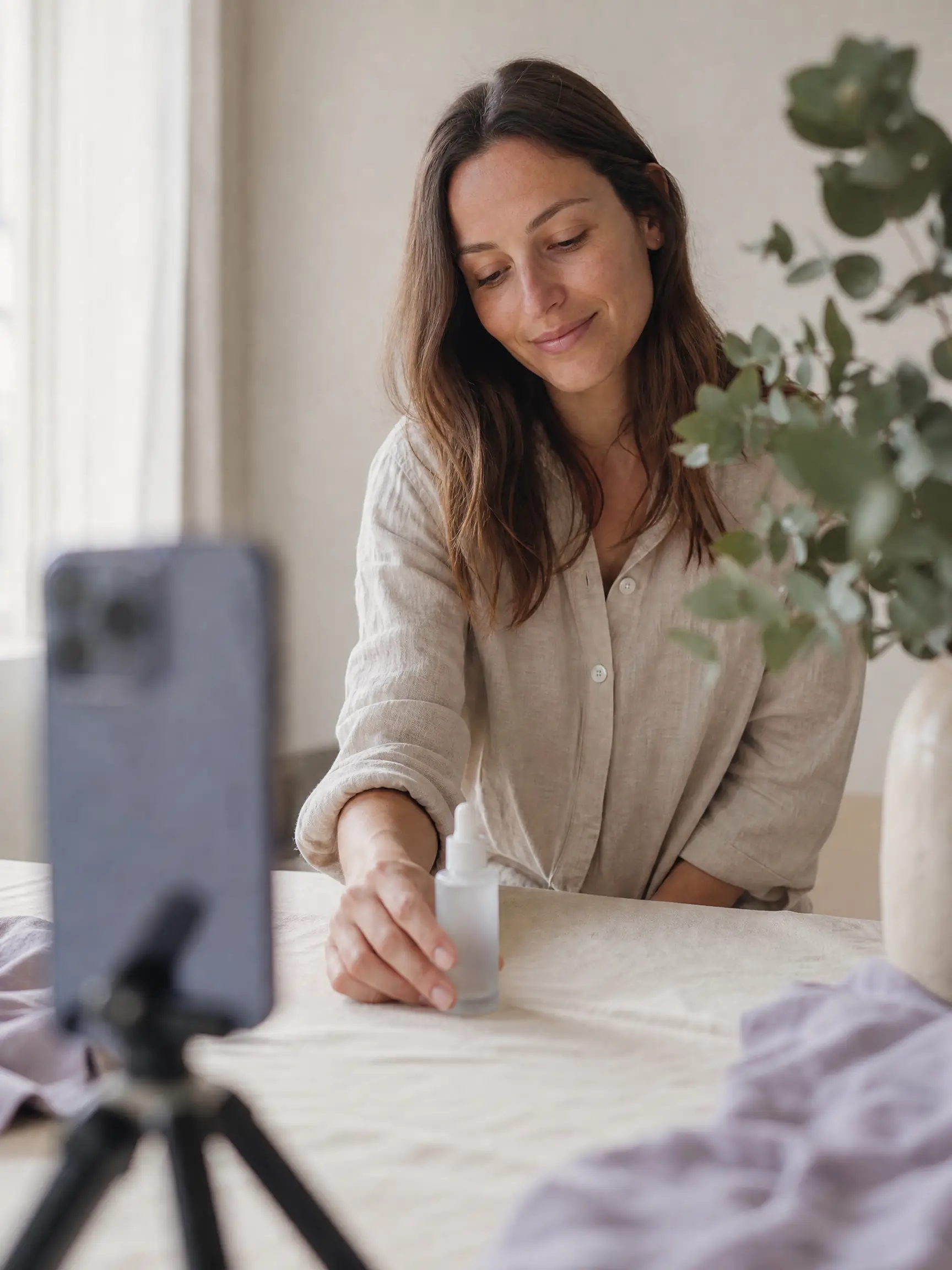 AI product video ad for a skincare bottle shot in a sunlit home studio